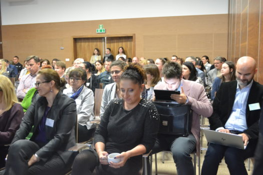 uczestnicy konferencji - kobiety i mężczyźni siedzą na dużej sali